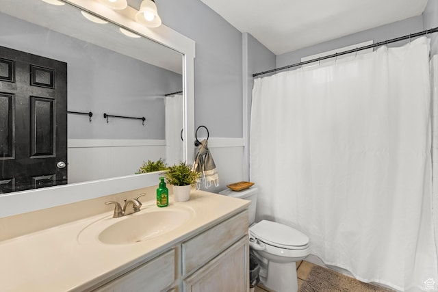 1933 N 120 W, Tooele, UT 84074 - bathroom featuring toilet, vanity, and wainscoting