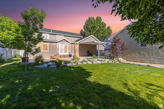 1933 N 120 W, Tooele, UT 84074 - back of property at dusk with french doors, entry steps, and a patio area