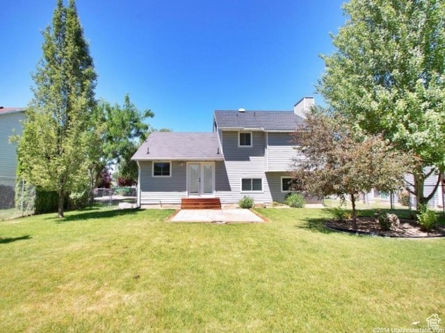 2182 N 850 W, Clinton, UT 84015 - rear view of house featuring french doors, a patio area, and a chimney