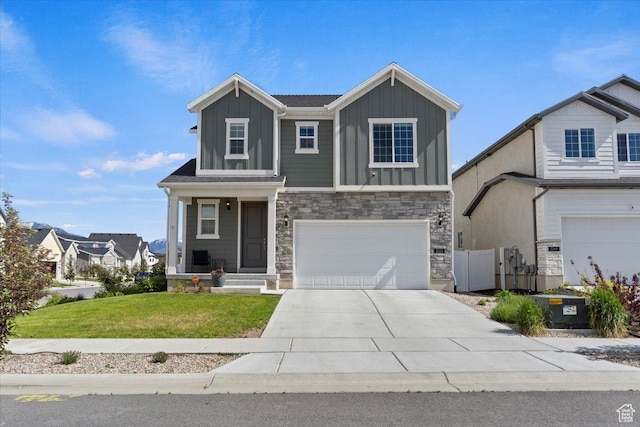 2221 W Prevedel Dr S, West Haven, UT 84401 - view of front facade with board and batten siding, a garage, stone siding, and driveway