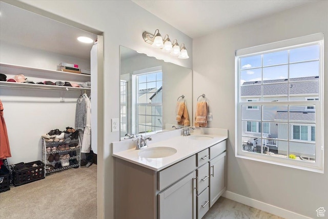 2221 W Prevedel Dr S, West Haven, UT 84401 - bathroom with a walk in closet, double vanity, and baseboards