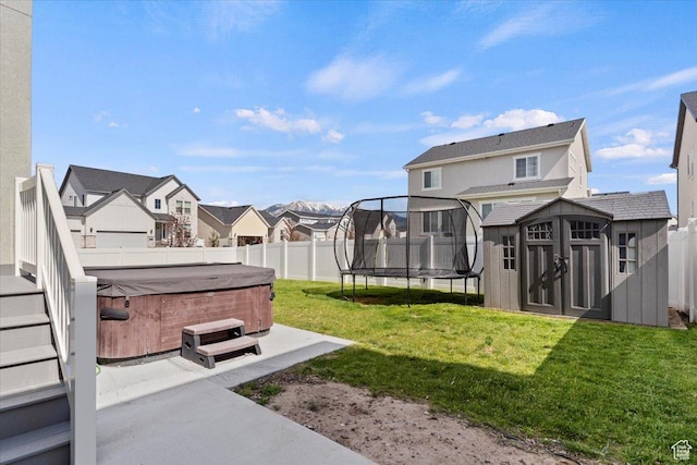 2221 W Prevedel Dr S, West Haven, UT 84401 - view of yard featuring a hot tub, a trampoline, a residential view, and a patio area