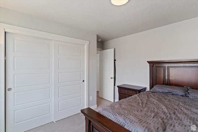 2221 W Prevedel Dr S, West Haven, UT 84401 - bedroom featuring light colored carpet, a closet, and a textured ceiling