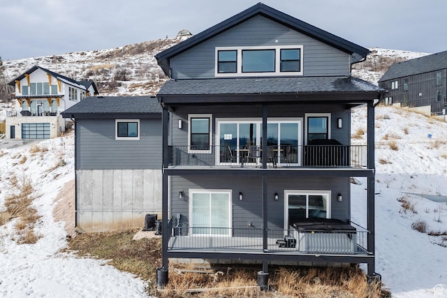660 N Lochwood Dr # 69, Garden City, UT 84028 - view of front of home featuring a balcony, roof with shingles, and a mountain view