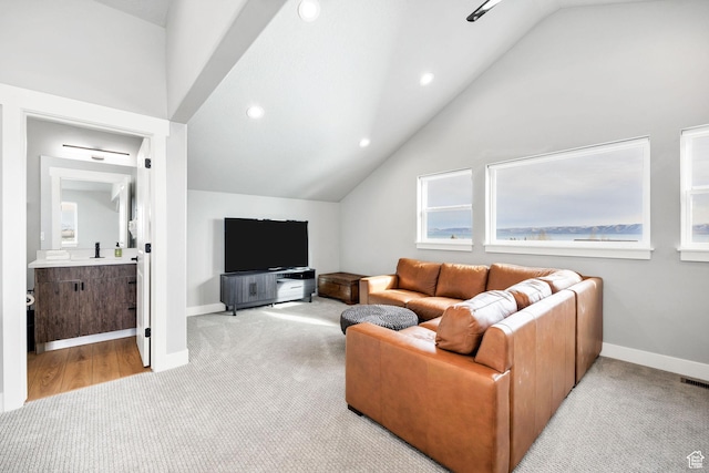 660 N Lochwood Dr # 69, Garden City, UT 84028 - carpeted living room with lofted ceiling, recessed lighting, and baseboards