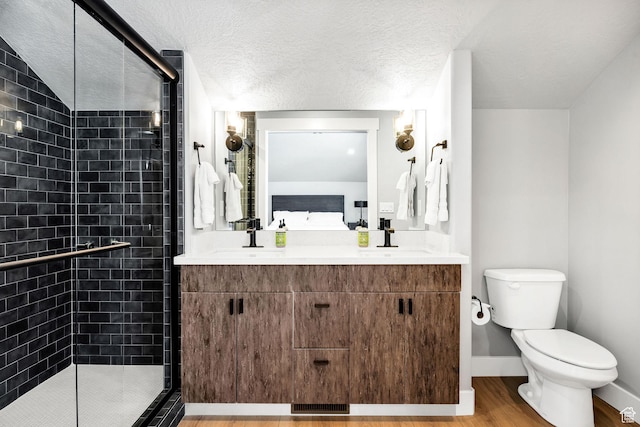 660 N Lochwood Dr # 69, Garden City, UT 84028 - full bathroom with ensuite bathroom, toilet, a stall shower, wood finished floors, and double vanity