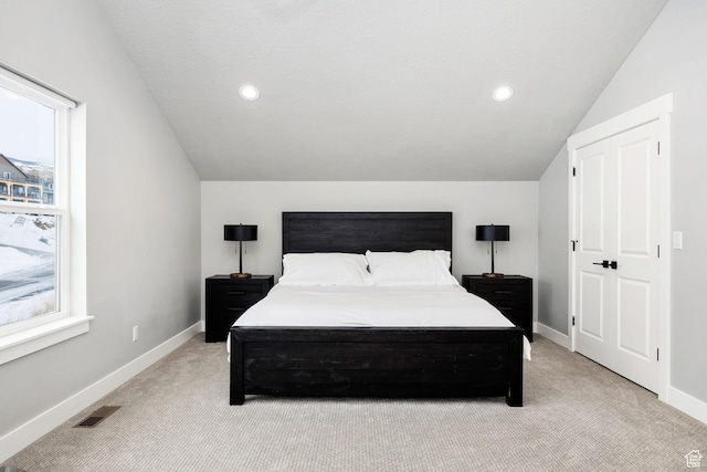 660 N Lochwood Dr # 69, Garden City, UT 84028 - bedroom with light colored carpet, vaulted ceiling, baseboards, multiple windows, and recessed lighting
