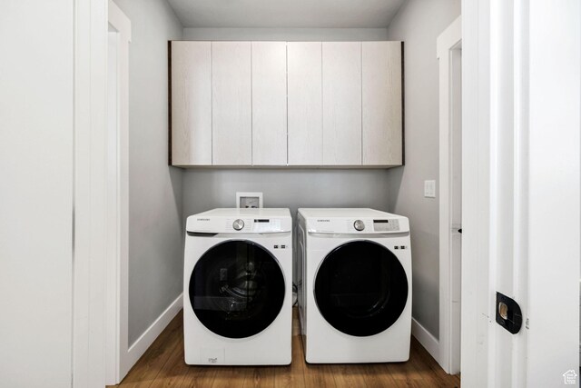 660 N Lochwood Dr # 69, Garden City, UT 84028 - washroom featuring cabinet space, washing machine and clothes dryer, baseboards, and wood finished floors