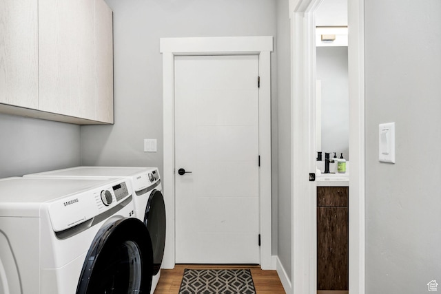 660 N Lochwood Dr # 69, Garden City, UT 84028 - laundry area with cabinet space, washing machine and dryer, and light wood-type flooring