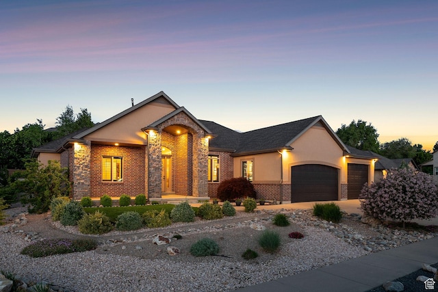 7538 S 1740 E, South Weber, UT 84405 - view of front of property with an attached garage, stone siding, stucco siding, and driveway