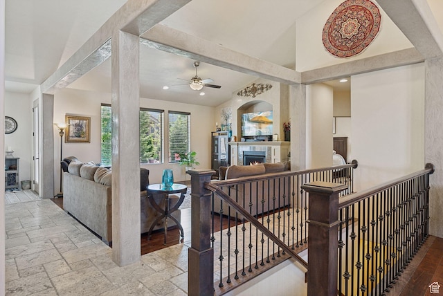 7538 S 1740 E, South Weber, UT 84405 - living room featuring ceiling fan, a warm lit fireplace, stone tile floors, recessed lighting, and lofted ceiling