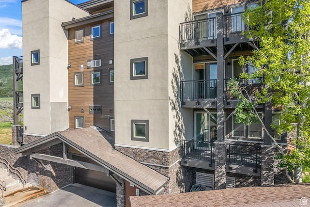 6749 N 2200 W Unit B102, Park City, UT 84098 - view of apartment building / complex with asphalt driveway and an attached garage