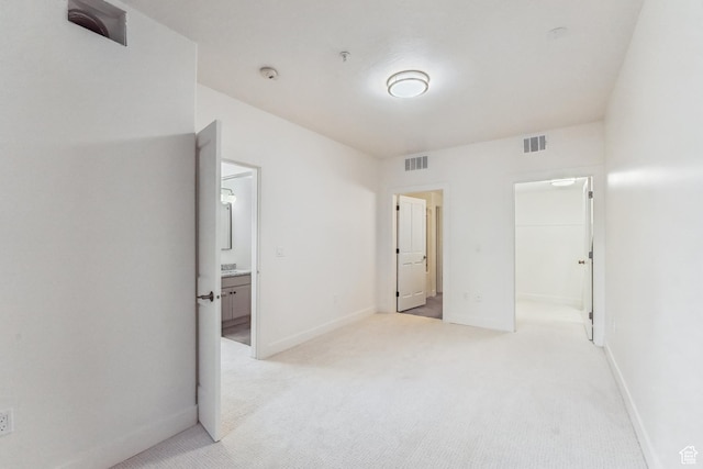 6749 N 2200 W Unit B102, Park City, UT 84098 - unfurnished bedroom featuring light carpet, a walk in closet, baseboards, and ensuite bath