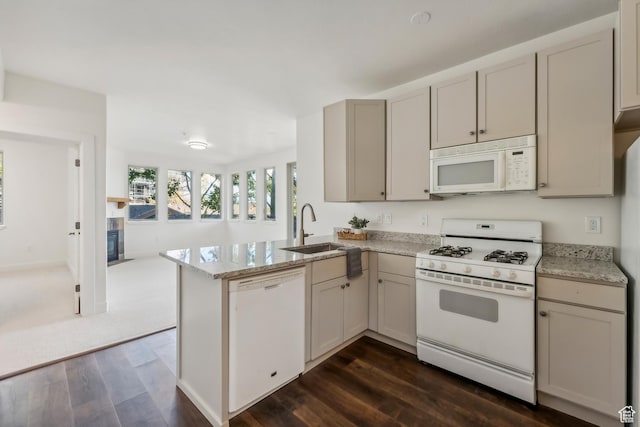 6749 N 2200 W Unit B102, Park City, UT 84098 - kitchen with white appliances, a sink, dark wood-style floors, a peninsula, and a glass covered fireplace