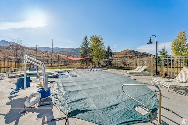6749 N 2200 W Unit B102, Park City, UT 84098 - view of pool with a fenced backyard, a mountain view, and a patio