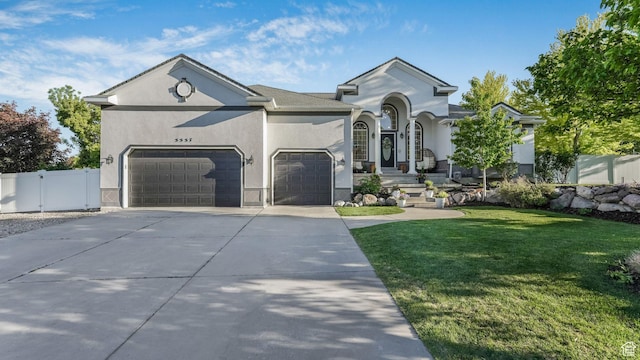 5557 W 13680 S, Herriman, UT 84096 - view of front of home with concrete driveway, a garage, and stucco siding