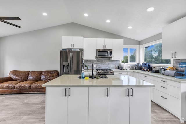 5131 W 6275 S, West Jordan, UT 84081 - kitchen featuring stainless steel appliances, vaulted ceiling, recessed lighting, backsplash, and light countertops