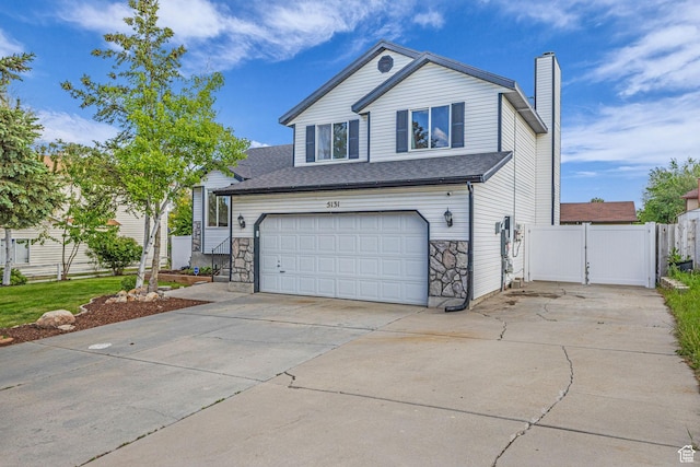 5131 W 6275 S, West Jordan, UT 84081 - view of front of home with a gate, a garage, driveway, a chimney, and stone siding