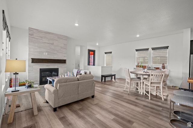 11242 S Willow Dr, South Jordan, UT 84009 - living area with wood finished floors, recessed lighting, a tiled fireplace, and baseboards