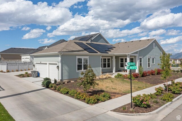11242 S Willow Dr, South Jordan, UT 84009 - ranch-style house with solar panels, an attached garage, a porch, driveway, and roof with shingles