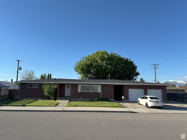 197 E Utah Ave, Payson, UT 84651 - ranch-style home with a garage, brick siding, and concrete driveway