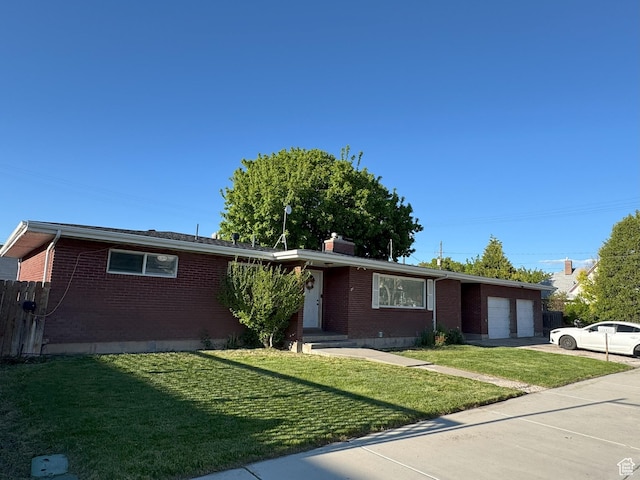 197 E Utah Ave, Payson, UT 84651 - ranch-style house featuring brick siding, an attached garage, a front lawn, and concrete driveway