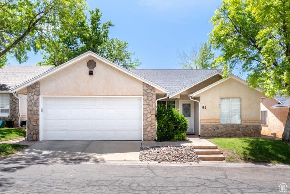 1040 N 1300th St Unit 52, St George, UT 84770 - ranch-style house with stone siding, a garage, stucco siding, and concrete driveway
