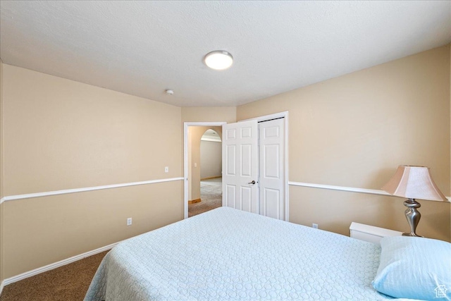 1040 N 1300th St Unit 52, St George, UT 84770 - bedroom with carpet, a closet, baseboards, and arched walkways