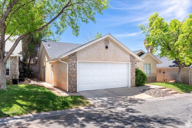 1040 N 1300th St Unit 52, St George, UT 84770 - view of front facade featuring stone siding, a garage, and driveway