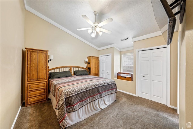 1040 N 1300th St Unit 52, St George, UT 84770 - bedroom with vaulted ceiling, ornamental molding, a textured ceiling, multiple closets, and dark colored carpet
