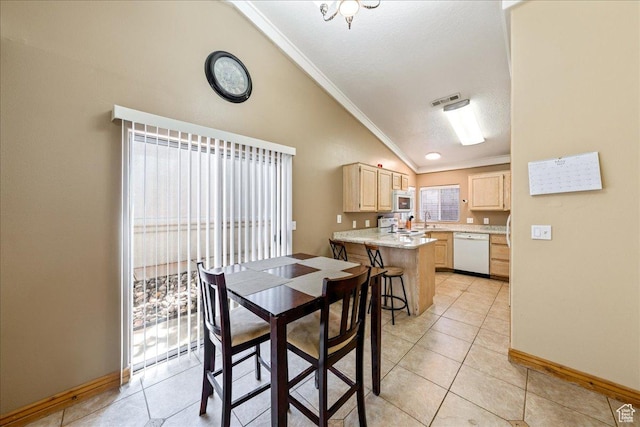 1040 N 1300th St Unit 52, St George, UT 84770 - dining area with vaulted ceiling, ornamental molding, baseboards, light tile patterned floors, and a textured ceiling