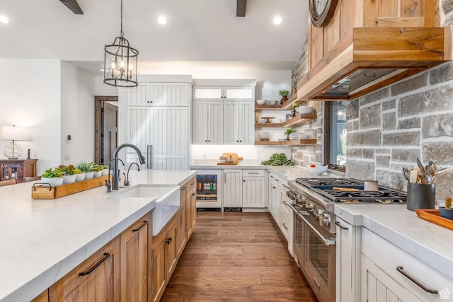 900 W Weber Canyon Rd, Oakley, UT 84055 - kitchen featuring range with two ovens, under cabinet range hood, wine cooler, light countertops, and tasteful backsplash
