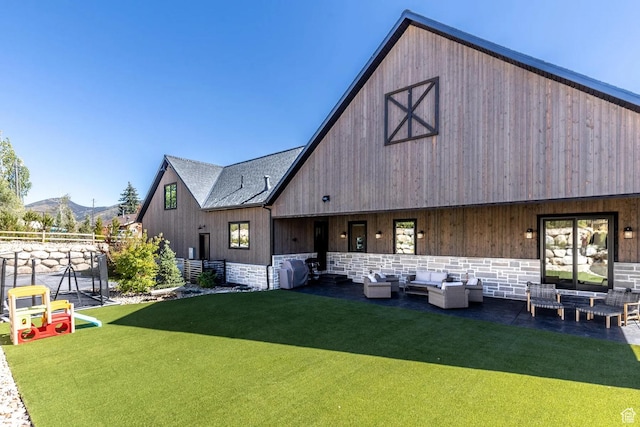 900 W Weber Canyon Rd, Oakley, UT 84055 - back of property featuring an outdoor living space, a lawn, stone siding, a mountain view, and a barn