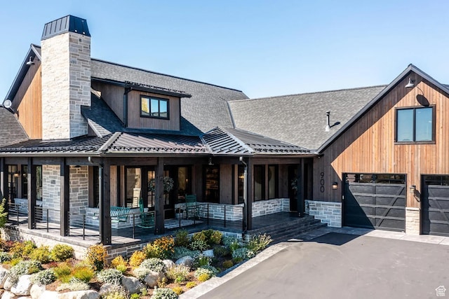 900 W Weber Canyon Rd, Oakley, UT 84055 - view of front of house featuring covered porch, a chimney, driveway, and a standing seam roof