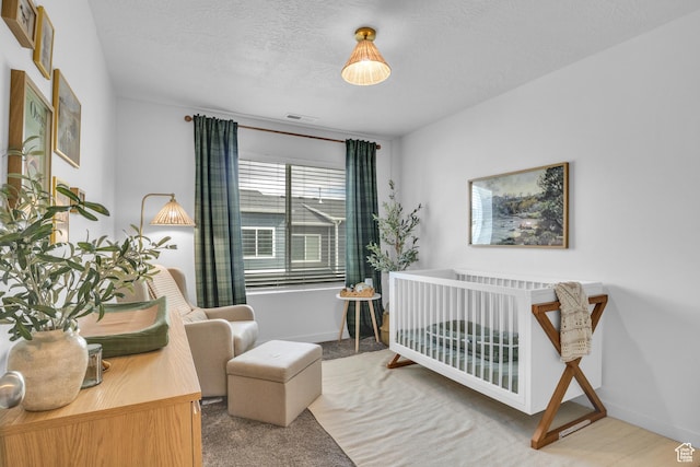 3791 W Soft Whisper Way, Herriman, UT 84096 - bedroom with a crib, a textured ceiling, baseboards, and carpet floors