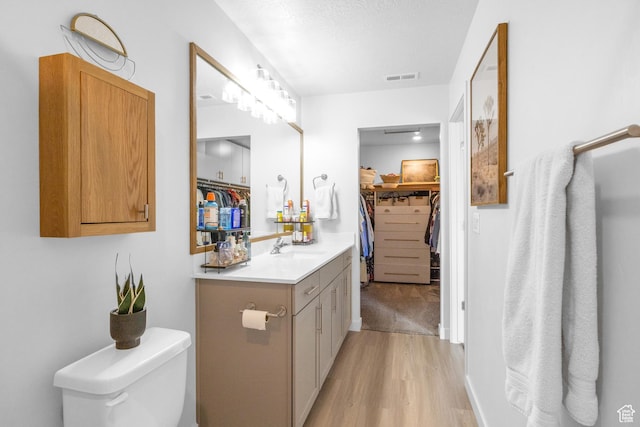 3791 W Soft Whisper Way, Herriman, UT 84096 - full bath featuring wood finished floors, vanity, toilet, and a walk in closet
