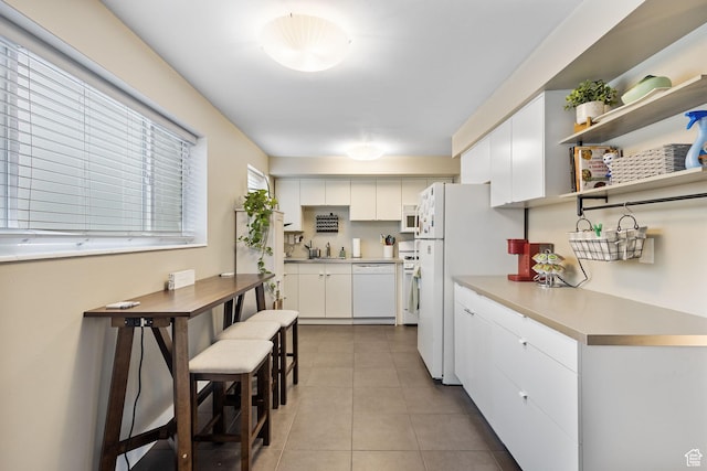 2220 E Murray Holladay Rd Unit 156, Holladay, UT 84117 - kitchen with white appliances, white cabinetry, a sink, and tile patterned flooring