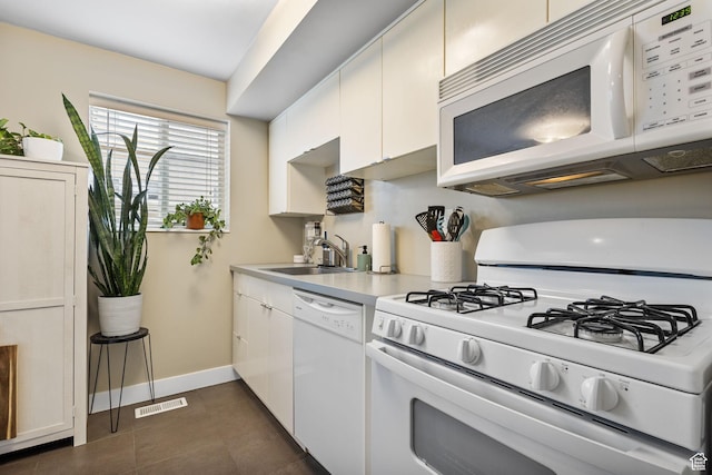 2220 E Murray Holladay Rd Unit 156, Holladay, UT 84117 - kitchen featuring white appliances, a sink, light countertops, baseboards, and white cabinetry