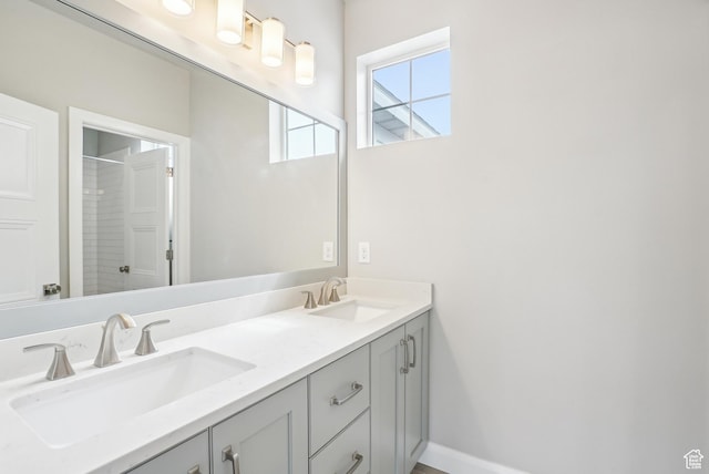 15056 S Sage Terrace Ln Unit 1014, Herriman, UT 84096 - bathroom featuring double vanity and a shower