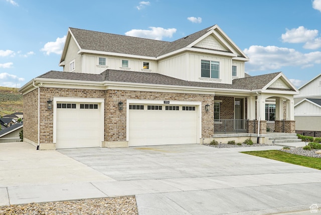 15056 S Sage Terrace Ln Unit 1014, Herriman, UT 84096 - view of front of house featuring covered porch, board and batten siding, concrete driveway, a garage, and brick siding