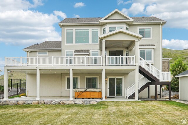 15056 S Sage Terrace Ln Unit 1014, Herriman, UT 84096 - rear view of house featuring a hot tub, stucco siding, a patio area, and a wooden deck