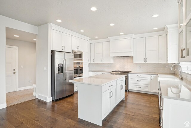 15056 S Sage Terrace Ln Unit 1014, Herriman, UT 84096 - kitchen featuring appliances with stainless steel finishes, a center island, light countertops, tasteful backsplash, and recessed lighting