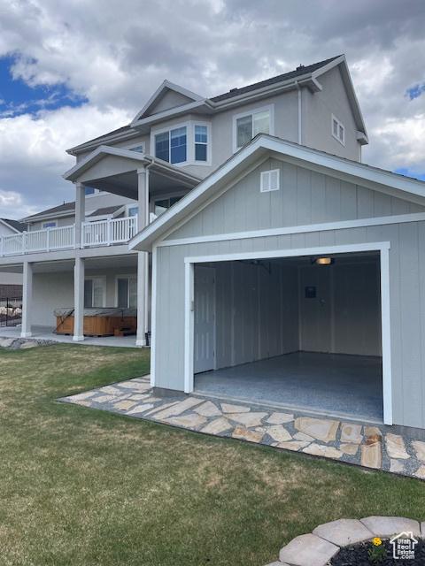 15056 S Sage Terrace Ln Unit 1014, Herriman, UT 84096 - view of front of property with a hot tub, a garage, a front yard, and a balcony