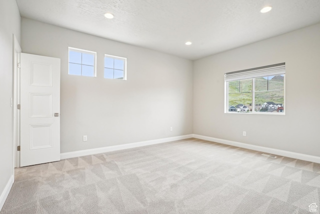 15056 S Sage Terrace Ln Unit 1014, Herriman, UT 84096 - unfurnished room featuring light colored carpet, plenty of natural light, baseboards, and recessed lighting