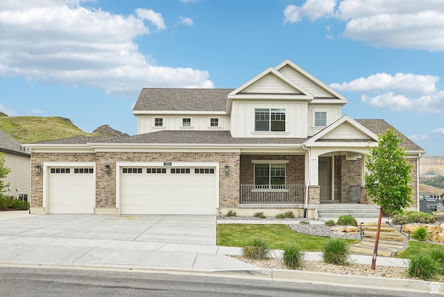 15056 S Sage Terrace Ln Unit 1014, Herriman, UT 84096 - view of front facade featuring driveway, an attached garage, covered porch, board and batten siding, and a front yard