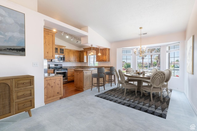 1055 E 900 S Unit 12, St George, UT 84790 - dining room featuring vaulted ceiling, a chandelier, light carpet, and baseboards