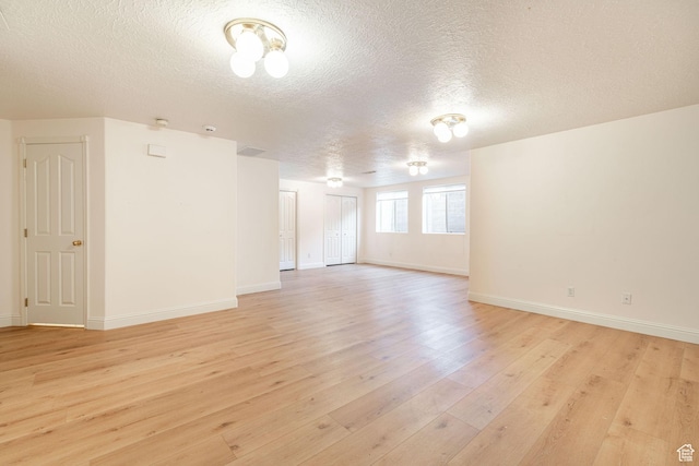 1055 E 900 S Unit 61, St George, UT 84790 - unfurnished room with a textured ceiling, light wood-type flooring, and baseboards