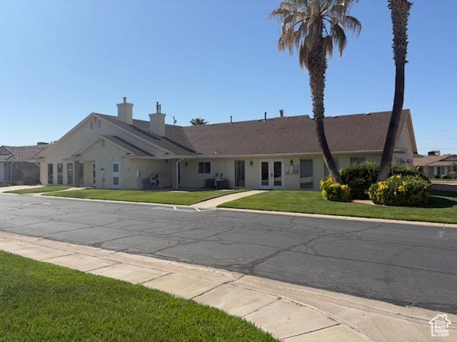1055 E 900 S Unit 61, St George, UT 84790 - ranch-style house featuring french doors, a front lawn, and a chimney