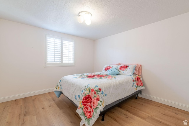 1055 E 900 S Unit 61, St George, UT 84790 - bedroom featuring wood finished floors, baseboards, and a textured ceiling