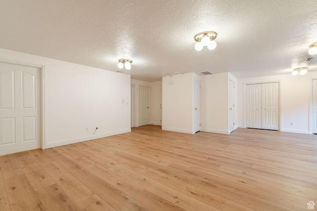 1055 E 900 S Unit 61, St George, UT 84790 - empty room featuring a textured ceiling, light wood-style flooring, and baseboards
